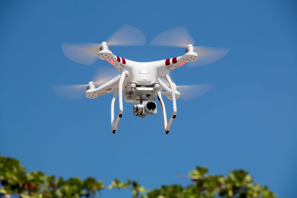 Survey drone capturing aerial imagery over open terrain