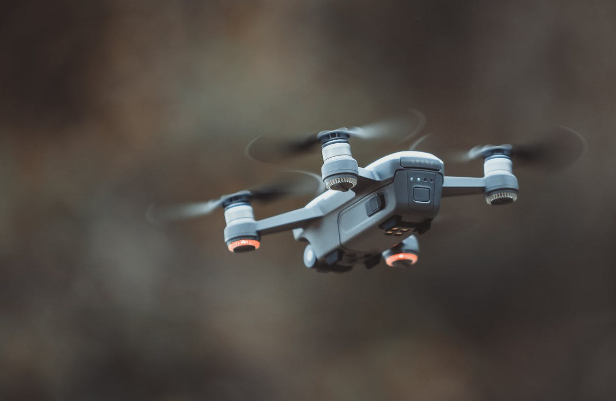 Drone pilot operating a remote controller in the field